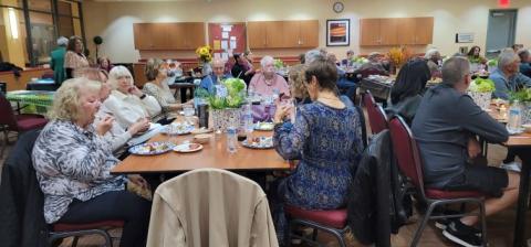 Members socializing over apps and desserts