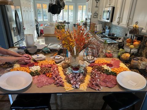 massive charcuterie board being prepared by Peg and Kelly